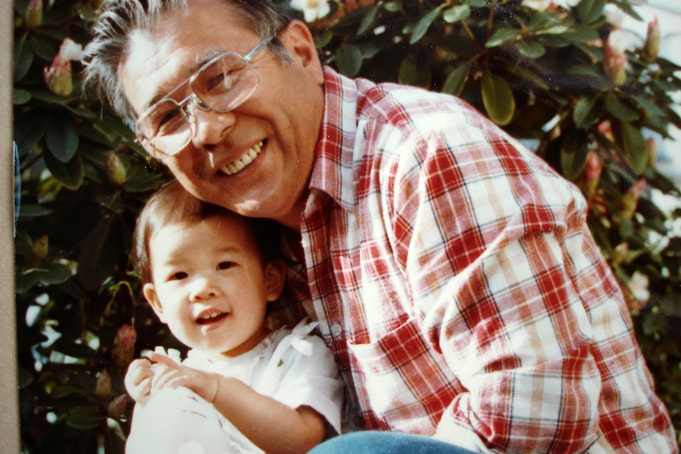 A young Japanese American girl, about 2 years old, with her grandfather. 